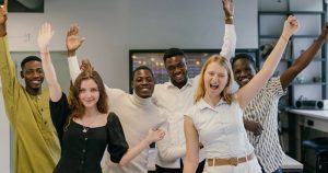 What to name your business article cover;6 people with one hand raised, cheering or just smiling